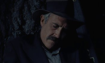 Movie still from “Johnny Got His Gun” (1971), directed by Dalton Trumbo – An older man wearing a suit and a hat; Close Up shot, High angle