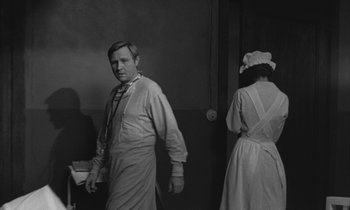 Movie still from “Johnny Got His Gun” (1971), directed by Dalton Trumbo – A black and white photo of a man and a woman; Medium shot, Over the shoulder angle