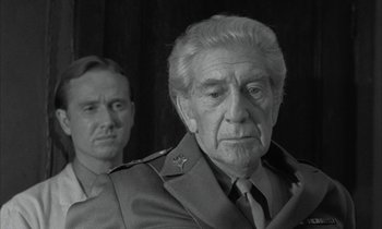 Movie still from “Johnny Got His Gun” (1971), directed by Dalton Trumbo – A black - and - white photo of a man and a man in uniform; Close Up shot, Over the shoulder angle
