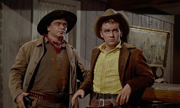 Movie still from “Johnny Guitar” (1954), directed by Nicholas Ray – A man and a man in a cowboy outfit; Medium shot, Low angle