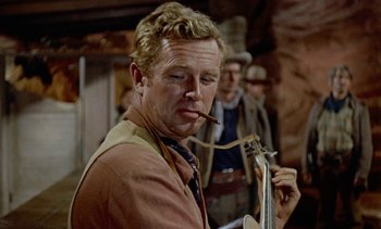 Movie still from “Johnny Guitar” (1954), directed by Nicholas Ray – A person holding a cigar; Close Up shot, Low angle