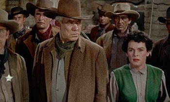 Movie still from “Johnny Guitar” (1954), directed by Nicholas Ray – A group of men and women wearing cowboy hats; Medium shot, Low angle