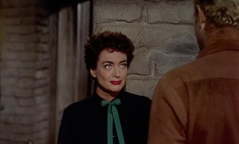 Movie still from “Johnny Guitar” (1954), directed by Nicholas Ray – A person wearing a suit and tie; Close Up shot, Over the shoulder angle