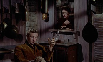 Movie still from “Johnny Guitar” (1954), directed by Nicholas Ray – A man and a woman sitting in front of a mirror; Medium shot, Over the shoulder angle