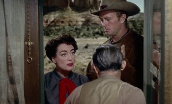 Movie still from “Johnny Guitar” (1954), directed by Nicholas Ray – A man and a woman are talking to another man; Medium shot, Over the shoulder angle