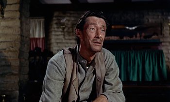 Movie still from “Johnny Guitar” (1954), directed by Nicholas Ray – A person sitting in a room; Close Up shot, Low angle