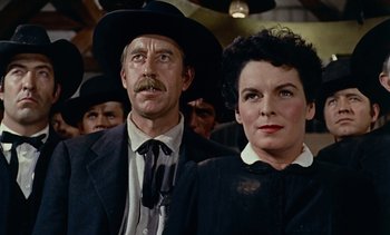 Movie still from “Johnny Guitar” (1954), directed by Nicholas Ray – A man and a woman standing next to each other; Close Up shot, Low angle
