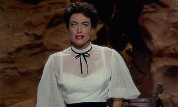 Movie still from “Johnny Guitar” (1954), directed by Nicholas Ray – A person wearing a dress; Close Up shot, High angle