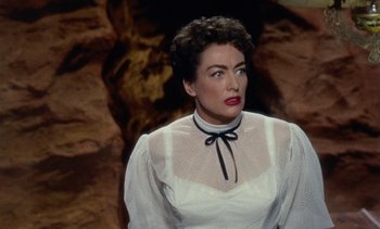 Movie still from “Johnny Guitar” (1954), directed by Nicholas Ray – A person wearing a white dress; Close Up shot, Over the shoulder angle