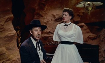 Movie still from “Johnny Guitar” (1954), directed by Nicholas Ray – A man and a woman standing next to each other; Medium shot, Low angle