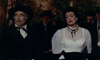 Movie still from “Johnny Guitar” (1954), directed by Nicholas Ray – A man and a woman dressed up in costume; Medium shot, Low angle