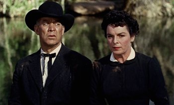 Movie still from “Johnny Guitar” (1954), directed by Nicholas Ray – An older man and a woman standing next to each other; Medium shot, Low angle