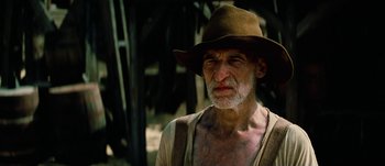 Movie still from “Jonah Hex” (2010), directed by Jimmy Hayward – An old man wearing a brown hat with a beard; Close Up shot, Low angle