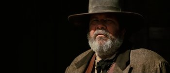 Movie still from “Jonah Hex” (2010), directed by Jimmy Hayward – An old man with a beard wearing a hat; Close Up shot, Low angle