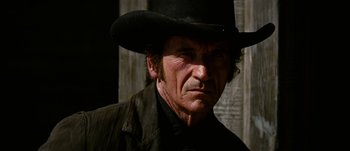 Movie still from “Jonah Hex” (2010), directed by Jimmy Hayward – An older man wearing a black hat and a black jacket; Close Up shot, Low angle