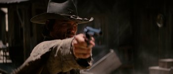 Movie still from “Jonah Hex” (2010), directed by Jimmy Hayward – A man in a cowboy hat holding a gun in his hand; Close Up shot, Low angle