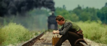 Movie still from “Jonah Hex” (2010), directed by Jimmy Hayward – A man kneeling down on the train tracks; Medium shot, Low angle