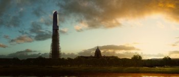 Movie still from “Jonah Hex” (2010), directed by Jimmy Hayward – A view of a building and a tree in front of a body of water; Extreme Wide shot, Low angle
