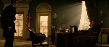 Movie still from “Jonah Hex” (2010), directed by Jimmy Hayward – A man standing in front of an open door in a room; Wide shot, Low angle