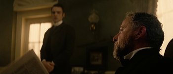 Movie still from “Jonah Hex” (2010), directed by Jimmy Hayward – A man in a black suit and a man in a white shirt; Close Up shot, Over the shoulder angle