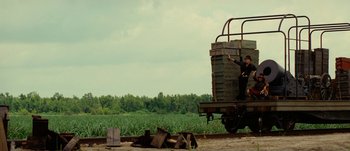 Movie still from “Jonah Hex” (2010), directed by Jimmy Hayward – A man standing on top of an old train car; Extreme Wide shot, Low angle
