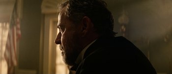 Movie still from “Jonah Hex” (2010), directed by Jimmy Hayward – A person wearing a suit and tie; Close Up shot, Low angle