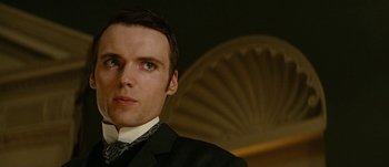 Movie still from “Jonah Hex” (2010), directed by Jimmy Hayward – A person wearing a suit and tie; Close Up shot, Low angle