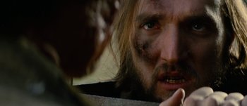 Movie still from “Jonah Hex” (2010), directed by Jimmy Hayward – A person with a beard looking into a mirror; Close Up shot, Low angle