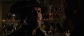 Movie still from “Jonah Hex” (2010), directed by Jimmy Hayward – A man in a cowboy hat looking to his left; Close Up shot, Low angle