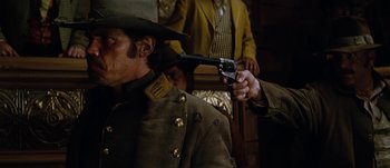 Movie still from “Jonah Hex” (2010), directed by Jimmy Hayward – A man holding a gun pointed at a man's face; Close Up shot, Over the shoulder angle
