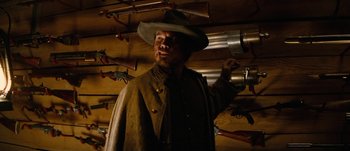 Movie still from “Jonah Hex” (2010), directed by Jimmy Hayward – A man wearing a hat and a long coat standing in a room; Medium shot, Low angle