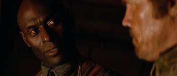 Movie still from “Jonah Hex” (2010), directed by Jimmy Hayward – A man's face in the dark; Close Up shot, Over the shoulder angle
