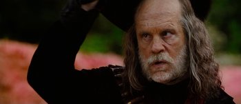 Movie still from “Jonah Hex” (2010), directed by Jimmy Hayward – An old man with long white hair and a goatee looking into the distance; Close Up shot, Low angle