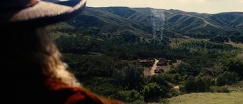 Movie still from “Jonah Hex” (2010), directed by Jimmy Hayward – A view from a helicopter of a valley with trees and hills in the background; Extreme Wide shot, High angle