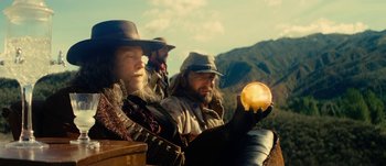Movie still from “Jonah Hex” (2010), directed by Jimmy Hayward – A group of men sitting next to each other on top of a hill; Medium shot, Low angle