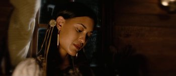 Movie still from “Jonah Hex” (2010), directed by Jimmy Hayward – A woman with long earrings looking down at her face; Close Up shot, Over the shoulder angle