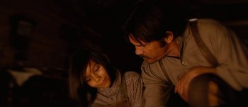 Movie still from “Jonah Hex” (2010), directed by Jimmy Hayward – A man and a woman looking at each other in the dark; Close Up shot, Over the shoulder angle