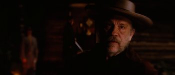 Movie still from “Jonah Hex” (2010), directed by Jimmy Hayward – A man in a cowboy hat is in the dark; Close Up shot, Over the shoulder angle