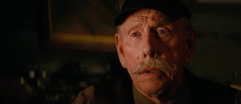 Movie still from “Jonah Hex” (2010), directed by Jimmy Hayward – An old man with a mustache wearing a hat; Close Up shot, Low angle