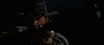 Movie still from “Jonah Hex” (2010), directed by Jimmy Hayward – A man in a cowboy hat smoking a cigarette; Close Up shot, Low angle