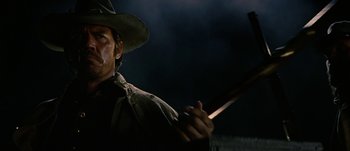 Movie still from “Jonah Hex” (2010), directed by Jimmy Hayward – A man in a cowboy hat holding an axe; Close Up shot, Low angle