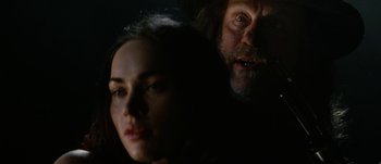 Movie still from “Jonah Hex” (2010), directed by Jimmy Hayward – A man and a woman in a dark room; Close Up shot, Over the shoulder angle