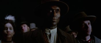 Movie still from “Jonah Hex” (2010), directed by Jimmy Hayward – A man wearing a hat and a suit; Close Up shot, Low angle