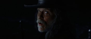 Movie still from “Jonah Hex” (2010), directed by Jimmy Hayward – A man with long grey hair wearing a black hat; Close Up shot, Low angle