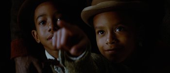Movie still from “Jonah Hex” (2010), directed by Jimmy Hayward – Two young boys wearing hats and one pointing at the camera; Close Up shot, Low angle