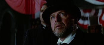 Movie still from “Jonah Hex” (2010), directed by Jimmy Hayward – A person wearing a top hat; Close Up shot, Low angle