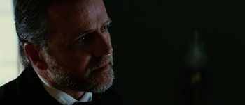 Movie still from “Jonah Hex” (2010), directed by Jimmy Hayward – A person wearing a suit and tie; Close Up shot, Low angle