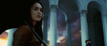 Movie still from “Jonah Hex” (2010), directed by Jimmy Hayward – A beautiful woman standing in front of pillars; Close Up shot, Low angle