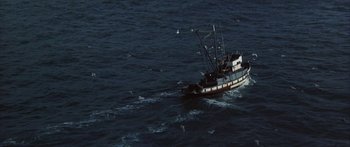 Movie still from “Jonathan Livingston Seagull” (1973), directed by Hall Bartlett – A fishing boat in the middle of the ocean; Extreme Wide shot, High angle