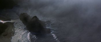 Movie still from “Jonathan Livingston Seagull” (1973), directed by Hall Bartlett – A bird is flying over a body of water; Extreme Wide shot, High angle